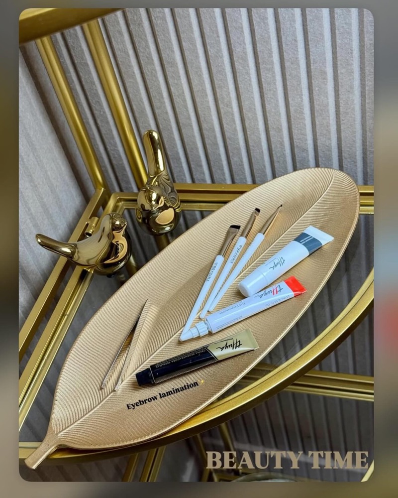 Brow and lash tools on a gold leaf tray at Beauty Time